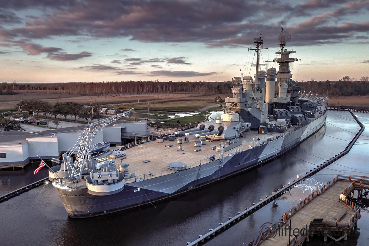 Starboard side of the USS North Carolina in Wilmington, with a crane in the foreground