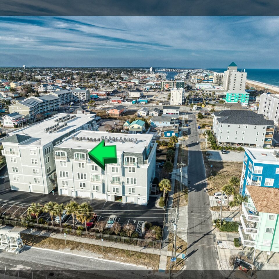 360 virtual tour screenshot showing aerial view of a coastal short-term rental property with navigation hotspot — STR virtual tours by Lifted Pictures