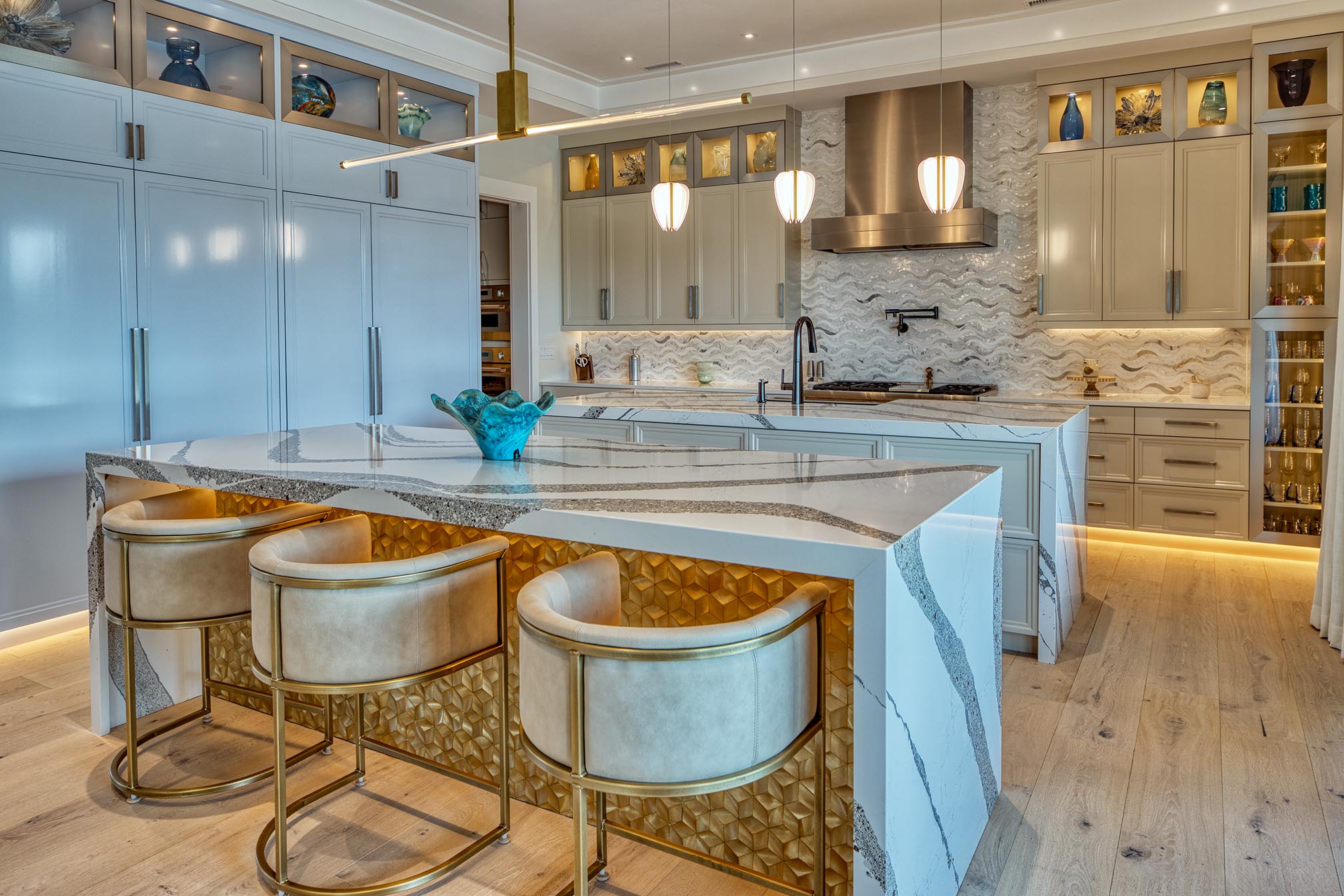 Custom luxury kitchen with layered lighting, stone countertops and crafted cabinetry