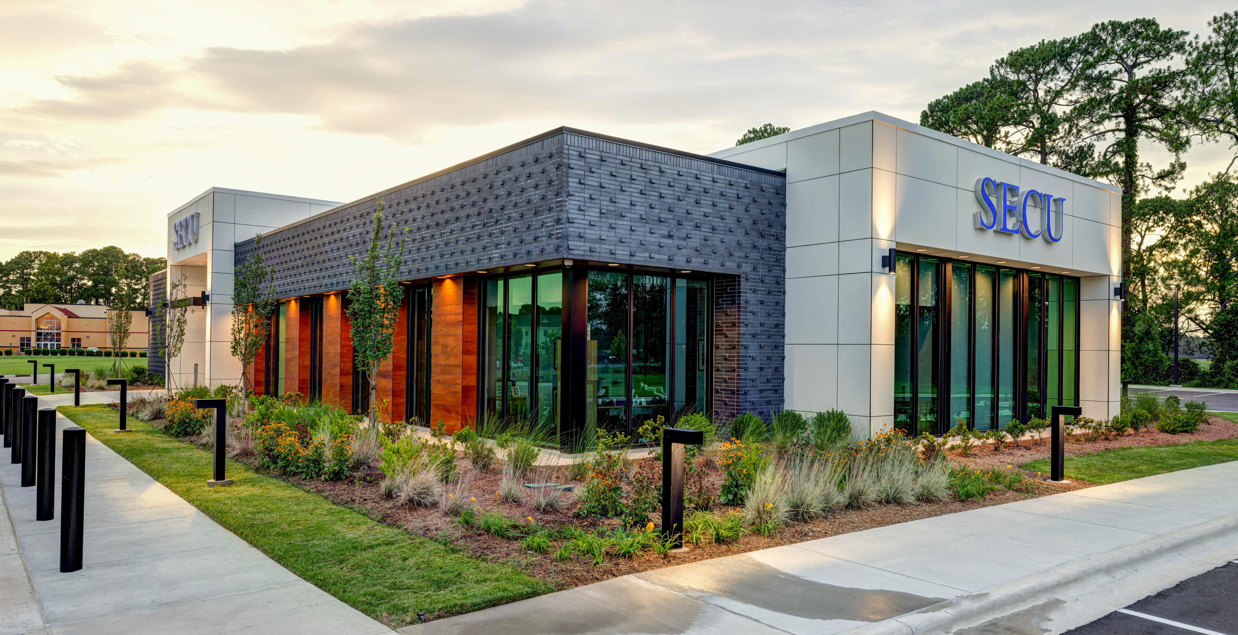 Contemporary SECU branch architecture photographed at dusk