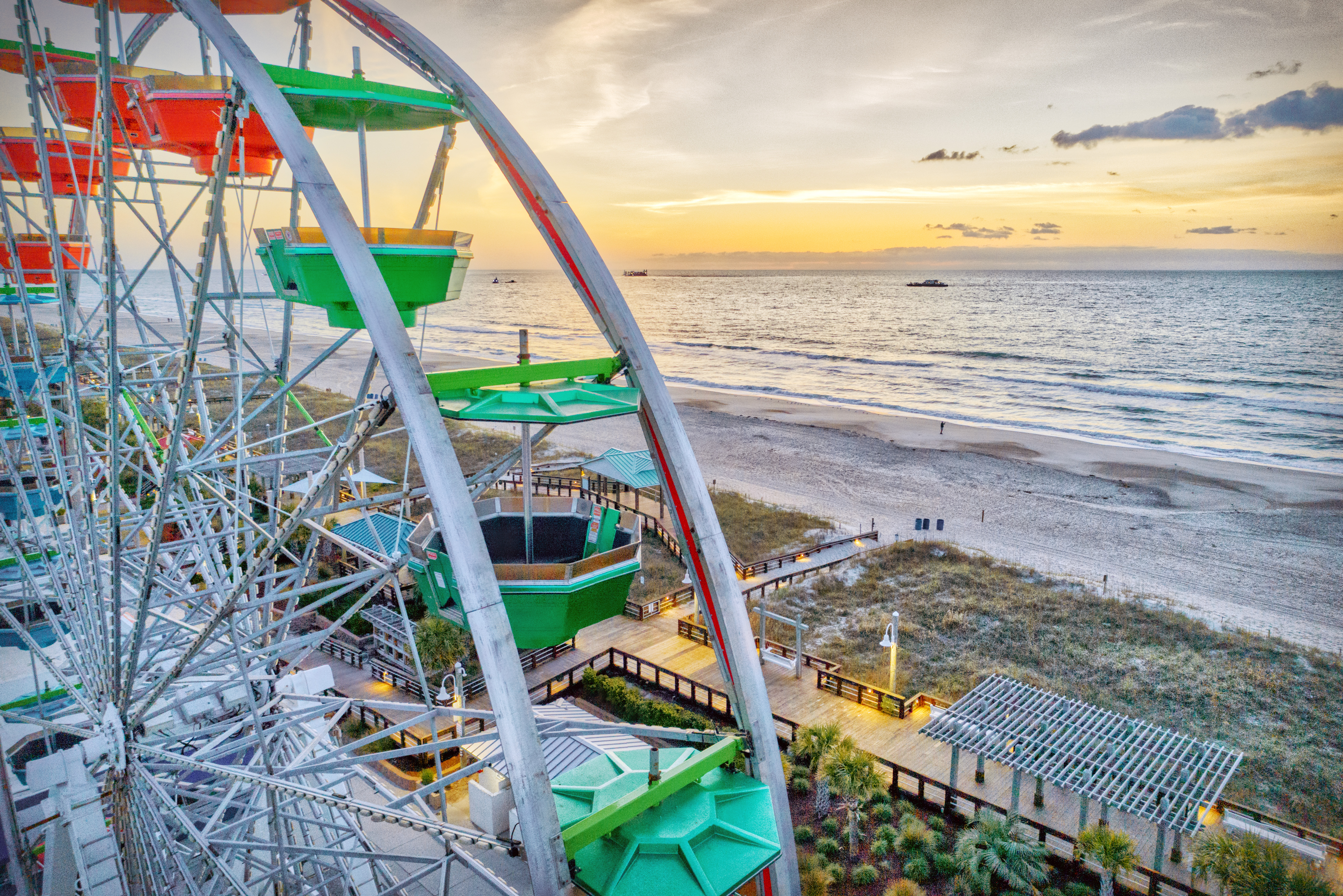 Ferris wheel and coastline at golden hour from an elevated perspective